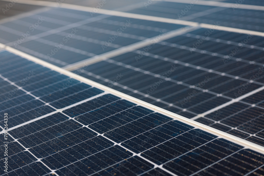 Green energy concept photo. Image with selective focus and camera movement. Solar panels on top of a consumer house. Green energy concept photo. Image with selective focus and camera movement. Solar panels on top of a consumer house.