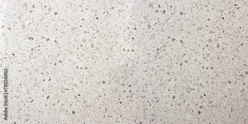 Terrazzo texture grey background. Classic retro style background. Small rose and beige pieces in concrete in a light style.