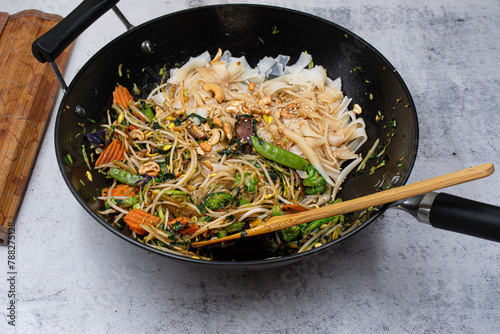 Cast iron wok with noodles and vegan stir fry,