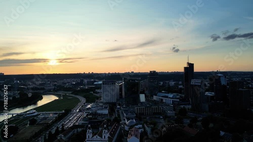 Flying over the old town of Vilnius at Summer sunset time. Modern city with many skyscrapers and car traffic lights, river. Beautiful city of Vilnius with modern buildings on a sunny day, Lithuania (ID: 788276767)