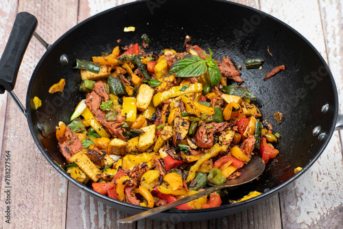 Vegan pepper and seitan stir fry in cast iron wok