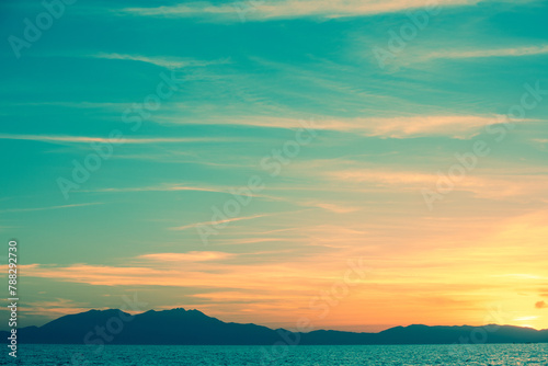 Seascape with mountains at sunset. Rockies in the evening. View of Mount Olympus on the horizon. Beautiful nature of Greece