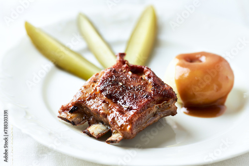 Fried pork ribs with potato dumplings on bright background. Close up.