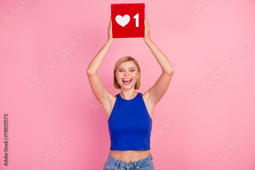Photo of pretty young woman hands hold like icon wear blue top isolated on pink color background