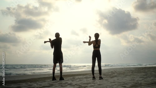 Wallpaper Mural Back side couple young two friends stretching arm before running at seaside. Young couple wearing sportswear running on sand sea ocean beach outdoor jog on seaside. Training athlete work out outdoor.
 Torontodigital.ca
