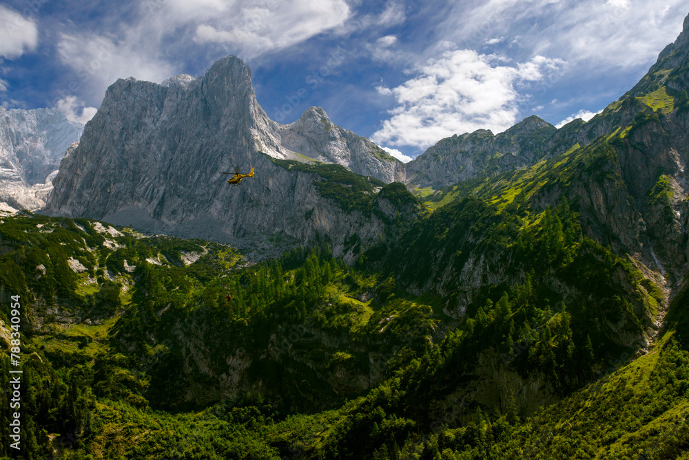 Lake Gosausee in Salzkammergut, Hind Gosau (Hinterer Gosausee) Austria. Rescue helicopter. Rescuers rescue climbers in the mountains. View of Dachstein. Tourism in Europe. Lake Gosausee in Salzkammergut, Hind Gosau (Hinterer Gosausee) Austria. Rescue helicopter. Rescuers rescue climbers in the mountains. View of Dachstein. Tourism in Europe.