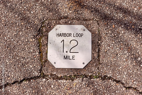 A close view of the distance marker sign on the path.