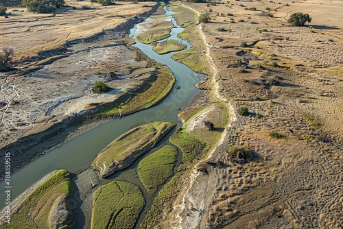 Aerial shot of a river nearly dry, its banks expanded and the bed mostly exposed. The drought’s impact on water levels is dramatical photo