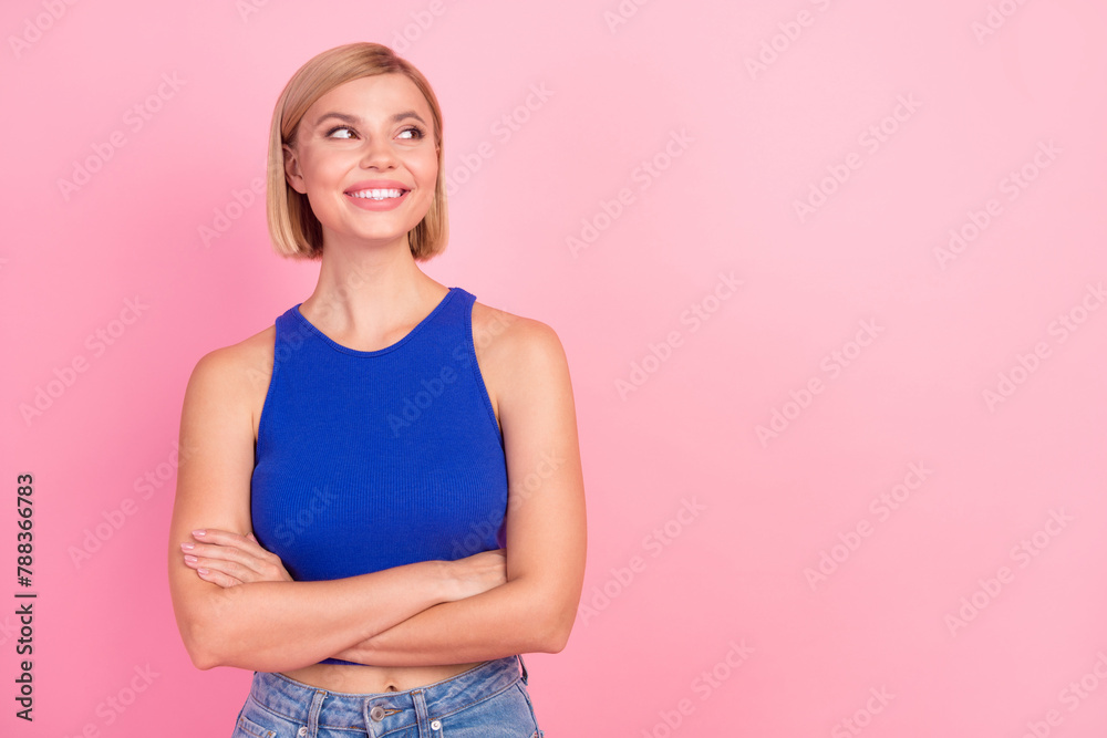 Naklejka premium Photo of pretty young woman folded hands look empty space wear blue top isolated on pink color background
