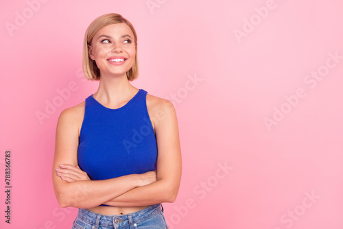 Photo of pretty young woman folded hands look empty space wear blue top isolated on pink color background