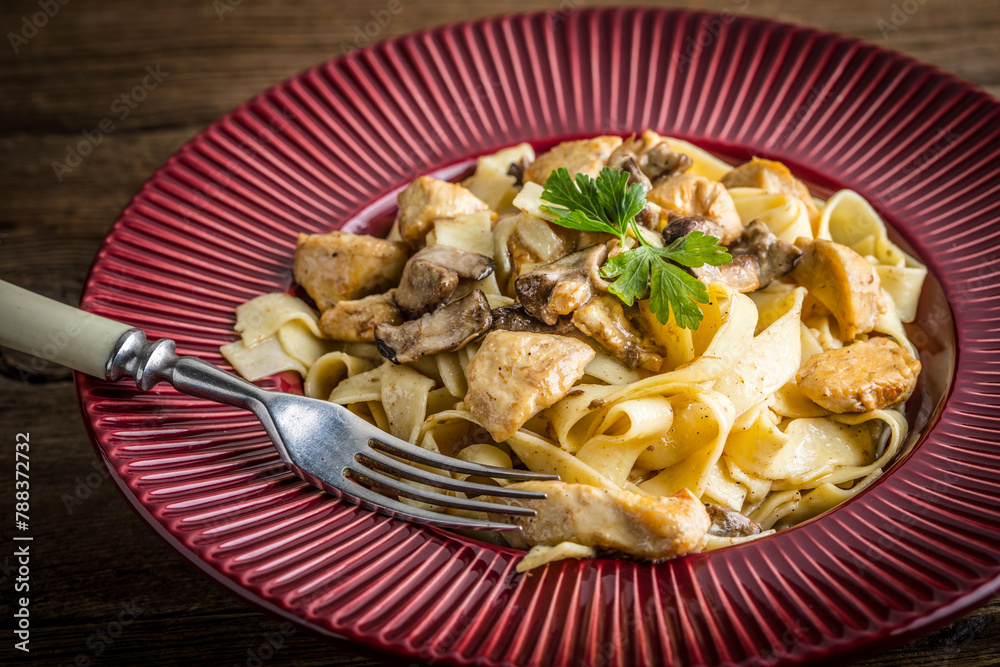 Tagliatelle pasta with forest mushrooms and chicken.