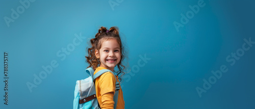 little girl smiling on a blue background, school, back to school, education