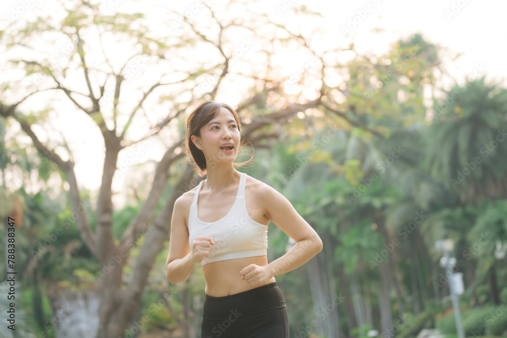 asian woman jogger running in green nature public park. asian woman jogger running in green nature public park.