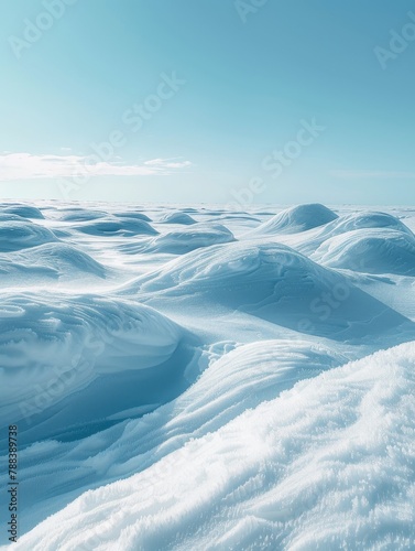 Snow drifts against a clear blue sky, capturing the simplicity and beauty of the Arctic landscape.