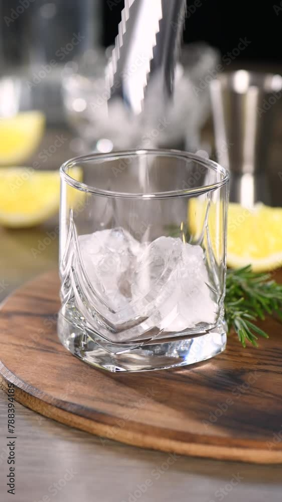 Preparing a cool cocktail Gin with tonic, lemon and rosemary. Vertical video, real time. Preparing a cool cocktail Gin with tonic, lemon and rosemary. Vertical video, real time.