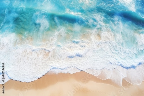 Beautiful natural summer vacation background. Aerial top view drone shot of turquoise waves breaking white bubbles on pristine white sand