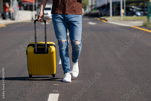 couple with yellow and blue suitcase at the airport waiting for the plane to enjoy their vacation © Paula