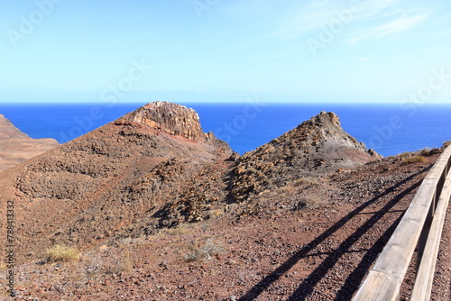 Desert mountain landscape surrounding Entallada lighthouse overlooking the ocean, Fuerteventura, Canary Islands, Spain, Atlantic, Europe