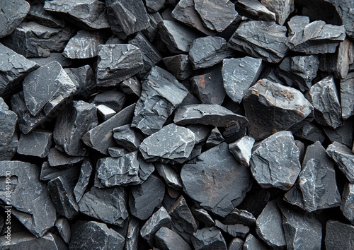 A pile of black rocks sitting closely together