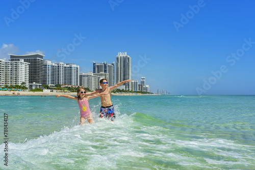 Family joy in a holiday - Miami Beach. Happy moments in the clean  water.