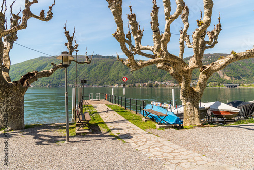 Lakefront in Bissone with the pier, overlooks of Lake Lugano, Ticino, Switzerland.