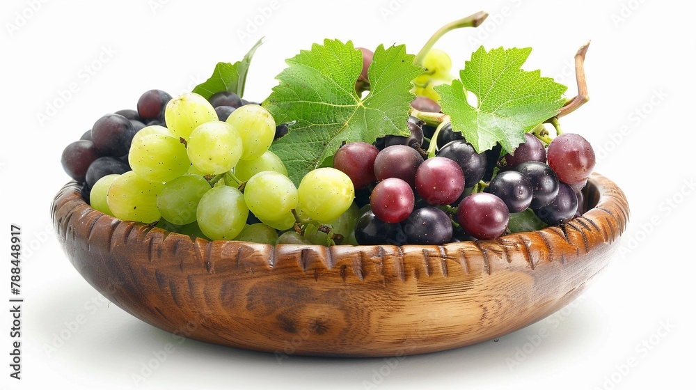 Delicious green and red grapes with leaves in a wooden bowl, isolated on white background Delicious green and red grapes with leaves in a wooden bowl, isolated on white background