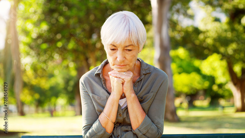 Fotografia Old woman, praying or thinking in park, sad with grief or loss, dementia diagnosis and health scare with faith or reflection