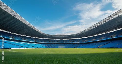 A wide-angle shot of an empty stadium with blue sky and clouds 
