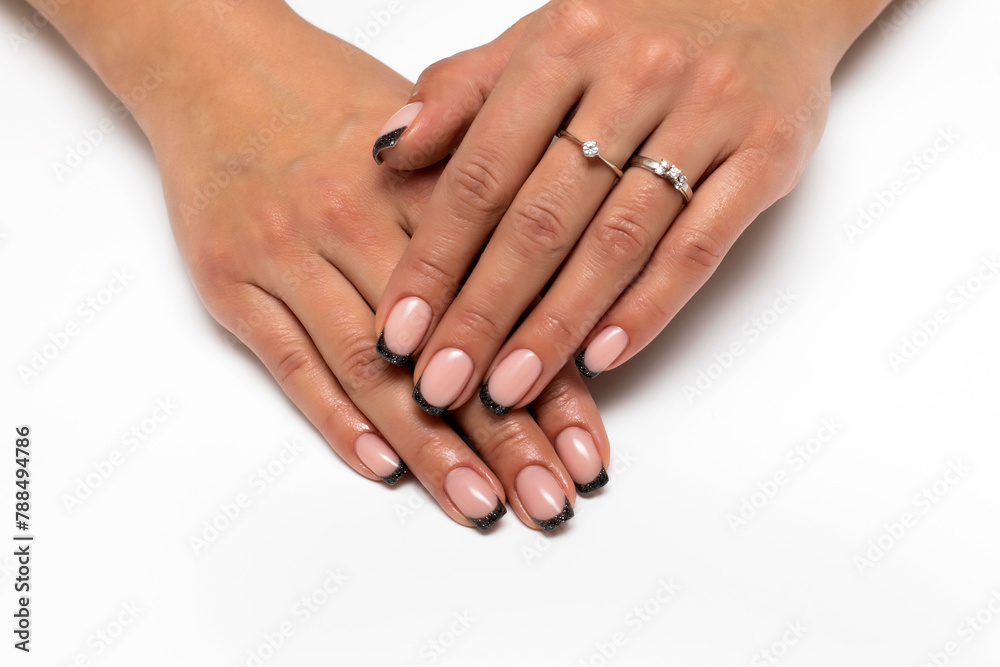 Tanned hands close-up. Black glitter French manicure on short square hands Tanned hands close-up. Black glitter French manicure on short square hands