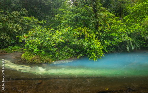 Blue river flowing through the rainforest, jungle on the banks of the Rio Celeste in Costa Rica, Landscape, Lush colors of a rainy day