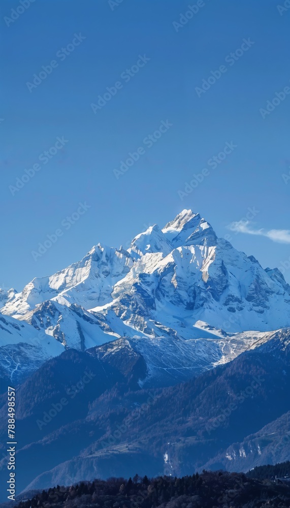Mountain Peaks Snow-capped mountain peaks under a clear blue sky, offering a majestic and serene background