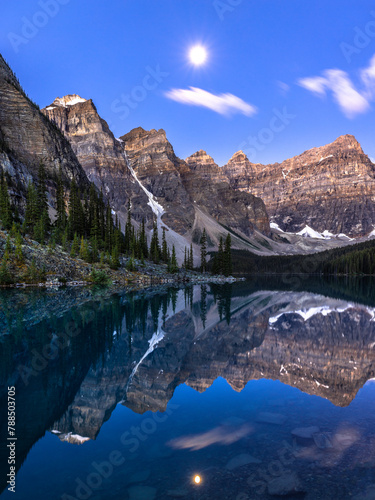 Alpine lake in mountains with light of the moon. Moraine Lake in Banff National Park, Canadian Rockies, Alberta, Canada.
