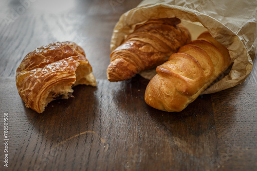 variety of ffreshly baked rench viennoiseries on wooden surface photo