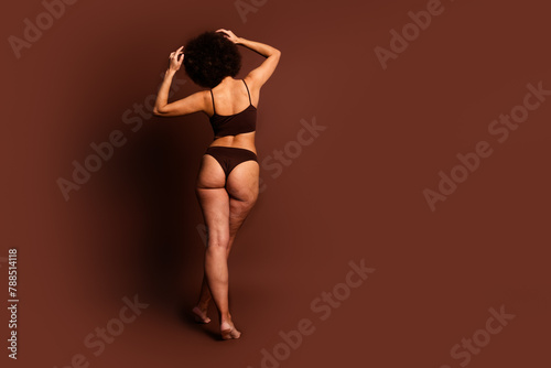 Full length photo of body positive dreamy lady standing back enjoying self acceptance emtpy space isolated brown color background