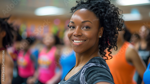 Enthusiastic individuals join a dance fitness class, moving to the rhythm of upbeat music and dynamic choreography, experiencing the joy and exhilaration of movement and activity.