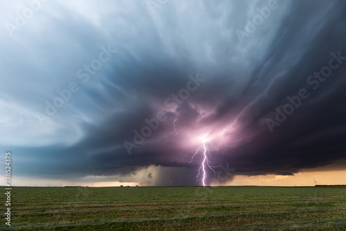 Severe weather. Thunderstorm lightning strike over a field © JSirlin