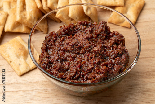Tablou pe pânză Glass bowl with traditional fresh homemade black olive tapenade