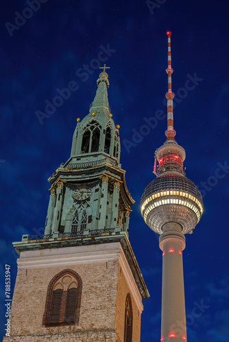 The famous TV Tower and the tower of St. Mary's Church at the Alexanderplatz in Berlin at night