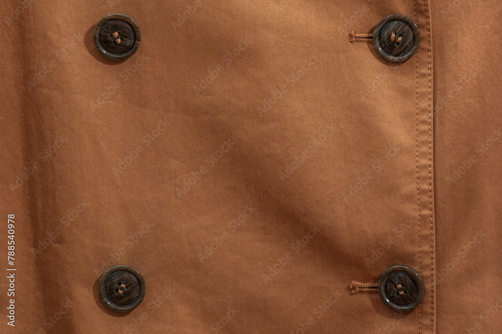 Brown buttons on a terracotta coat. Textile background with buttons. Brown buttons on a terracotta coat. Textile background with buttons.