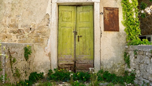  old house wall with wooden light green door  