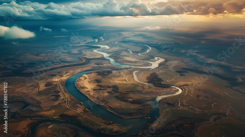 A dramatic aerial view of a meandering river snaking through a vast landscape, showcasing the grandeur and beauty of nature's waterways.