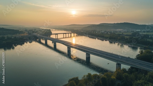 A majestic bridge spanning across a wide river, connecting two shores and symbolizing unity, progress, and human ingenuity. © Plaifah
