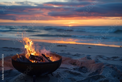 A bonfire crackles on the beach against the backdrop of a mesmerizing sunset over the ocean..