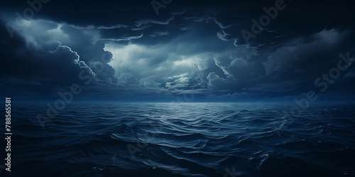 Dramatic dark blue stormy cloudy sky reflecting on the troubled water surface. Panoramic wide angle view. Fantasy stormy sea. Cinematic stormy ocean with rays of light in the center. Seascape in Chaos