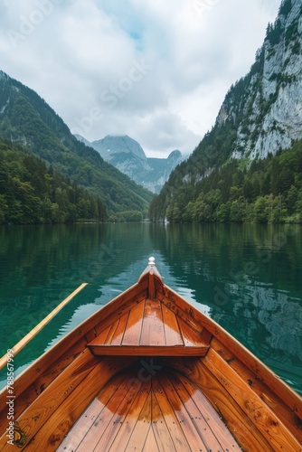 A serene image of a boat on a peaceful lake with majestic mountains in the background. Ideal for travel and nature concepts