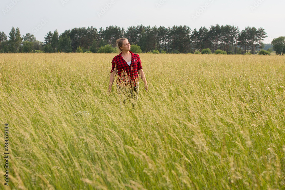 a woman in a field with her beloved pet on a walk. Summer in nature a woman in a field with her beloved pet on a walk. Summer in nature