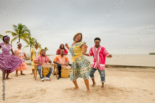 Young black couple dancing at a Caribbean beach party. photo