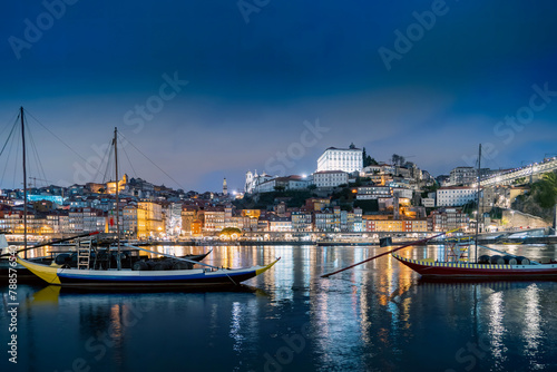 Porto  Portugal old town on the Douro River with traditional rabelo boats at night. With wine barrels from the port on the Douro River  Ribeira I in the background  Porto  Portugal.