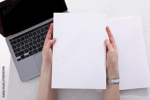 woman with a book, magazine and laptop on a white background. student. business. mockup