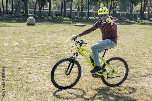 Modern cyclists wearing a face mask.
A man greeting with a thumbs up gesture.


